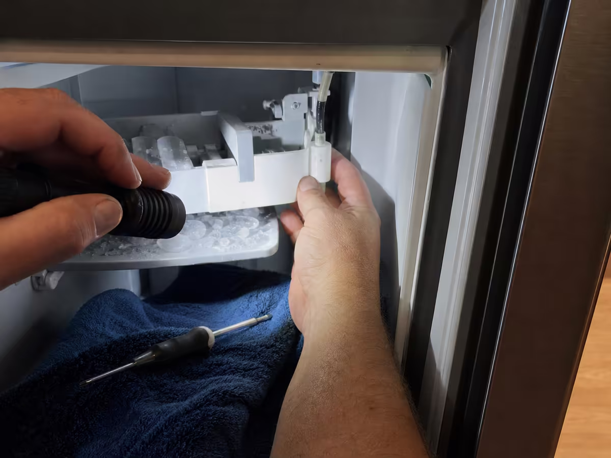 Probe testing a Sub-Zero control board to verify an alarm before replacement