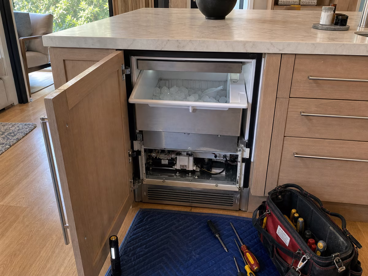 Wider view of a Sub-Zero undercounter ice maker installed in Mill Valley cabinetry